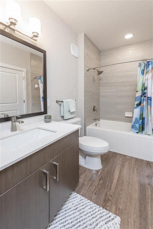 a bathroom with a toilet sink and bathtub at Verso Apartments, Davenport