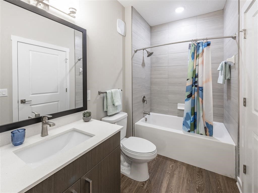 a bathroom with a toilet sink and bathtub at Verso Apartments, Davenport, Florida