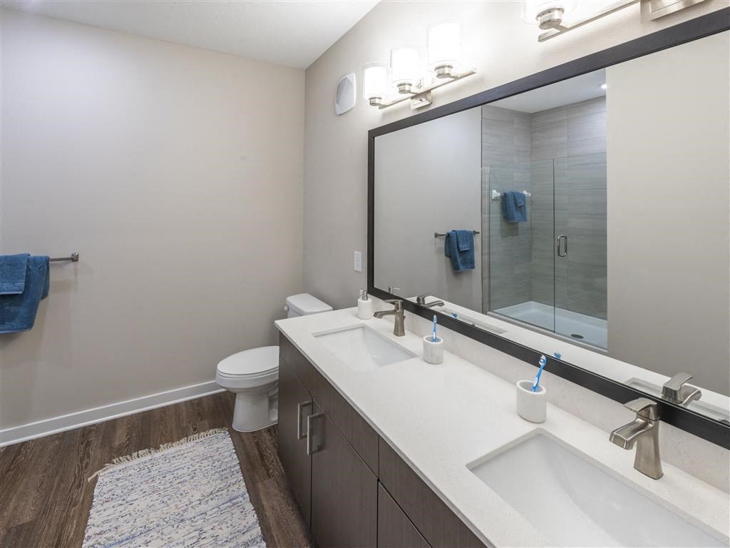a bathroom with two sinks and a toilet at Verso Apartments, Davenport, FL