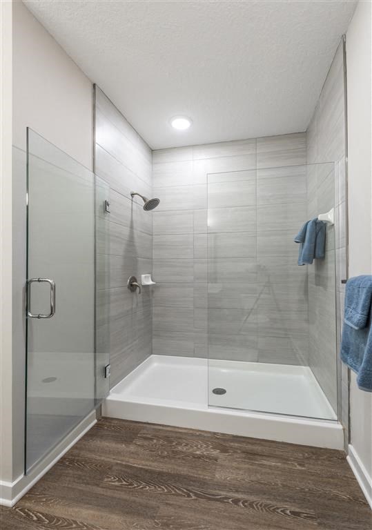 a bathroom with a shower and a bathtub at Verso Apartments, Davenport, FL, 33896
