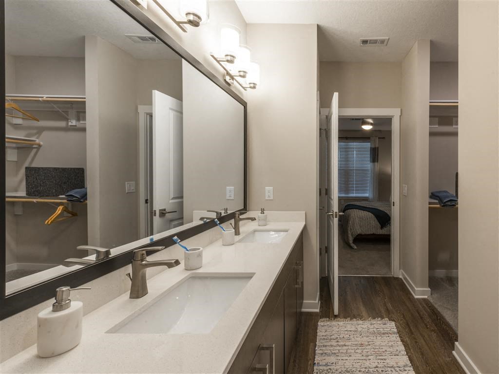 a bathroom with two sinks and a mirror at Verso Apartments, Florida, 33896
