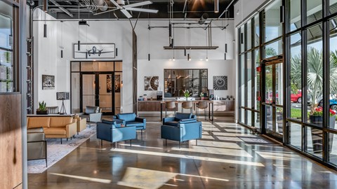A spacious lobby with a variety of seating options and a large glass wall.