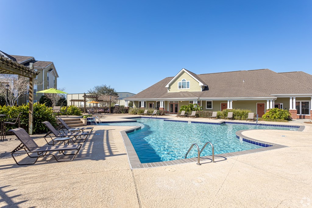 Crystal clear swimming pool with clubhouse view at Houma Highlands, Houma