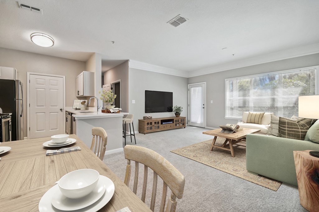 a living room with a table and chairs