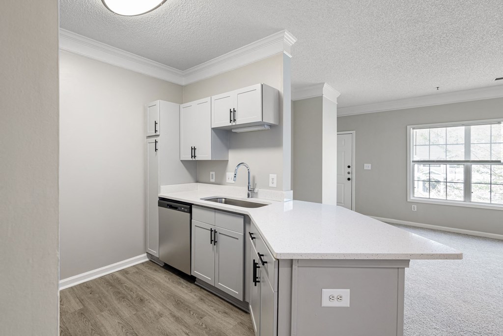 a kitchen with white cabinets and a white counter top
