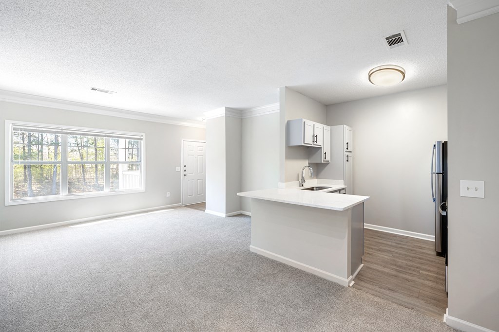 a kitchen and living room with a large window