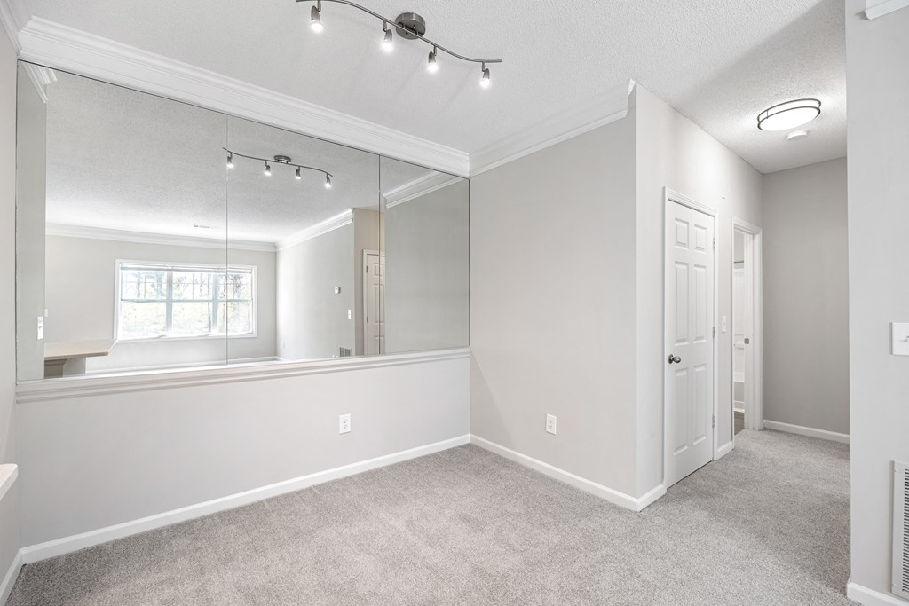 a bedroom with a large mirror