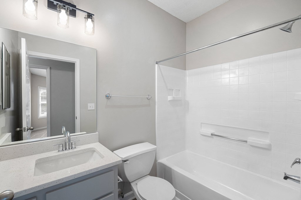 a bathroom with a bathtub and a toilet