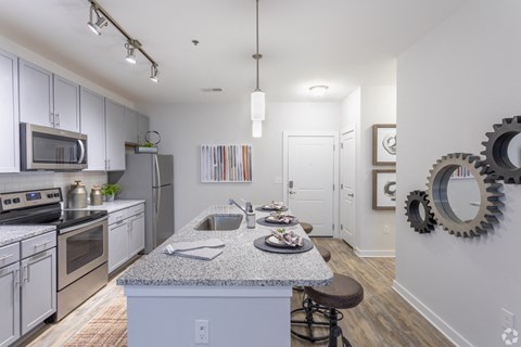 an open kitchen with granite counter tops and stainless steel appliances