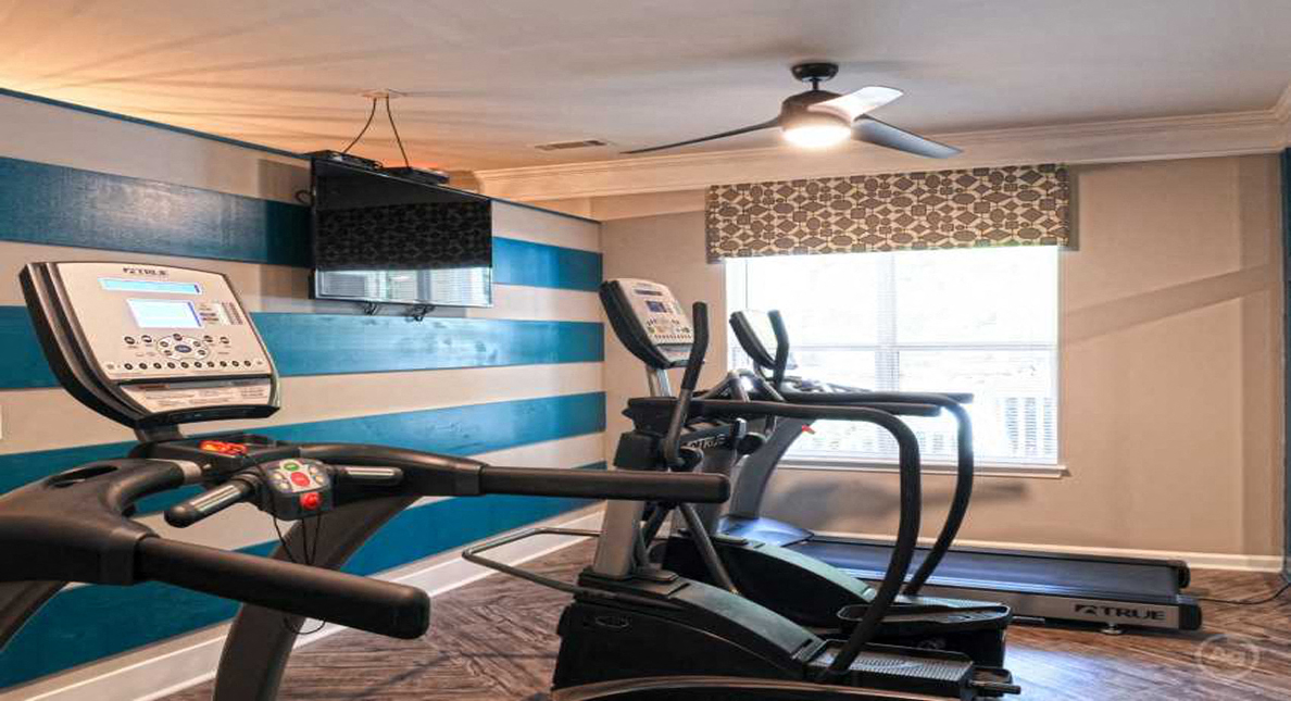Renovated fitness center with cardio equipment at The Columns at Oakwood, Oakwood, GA