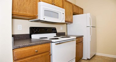 Fully equipped kitchen with over-the-range microwave at The Columns at Oakwood, 30566 - Photo Gallery 5