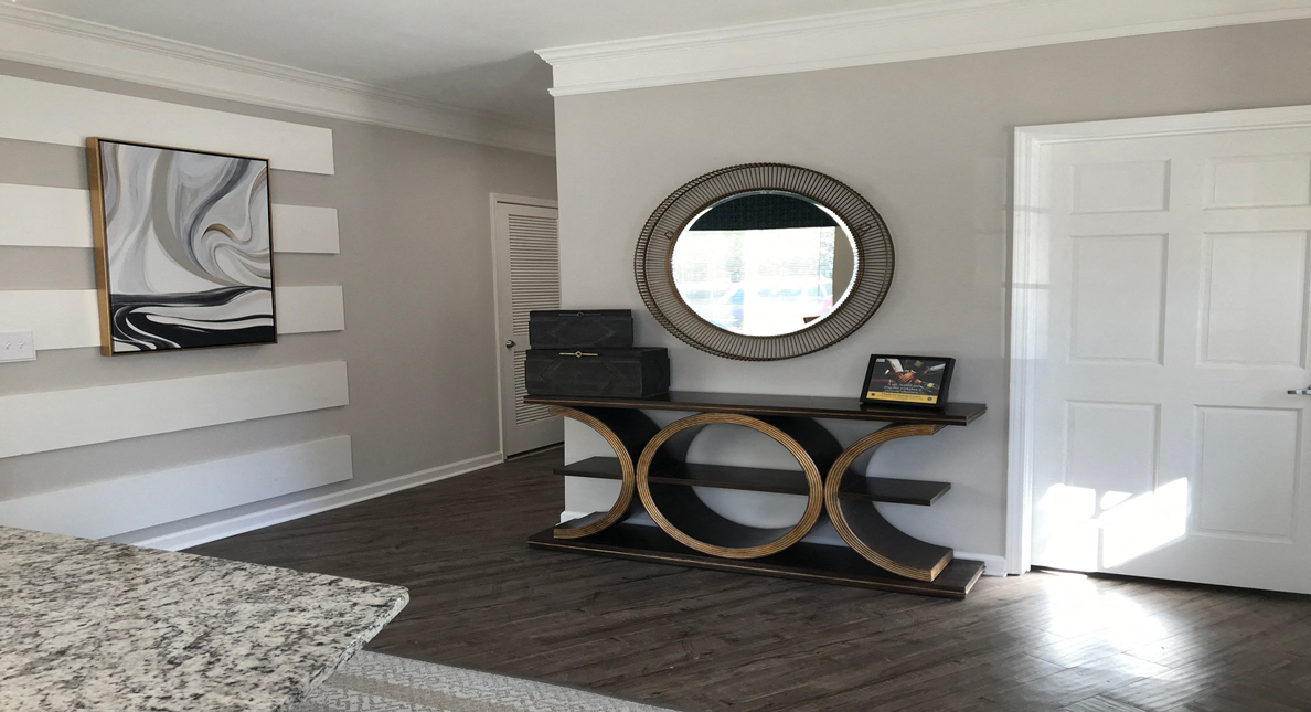 Leasing office with large decorative table and mirror at The Columns at Oakwood, Georgia