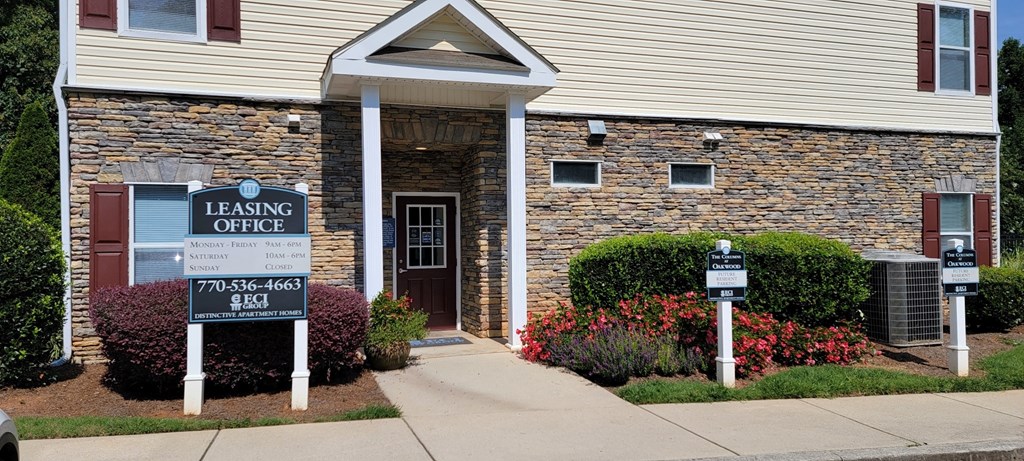 Leasing office exterior with signage at The Columns at Oakwood, Oakwood, Georgia 30566