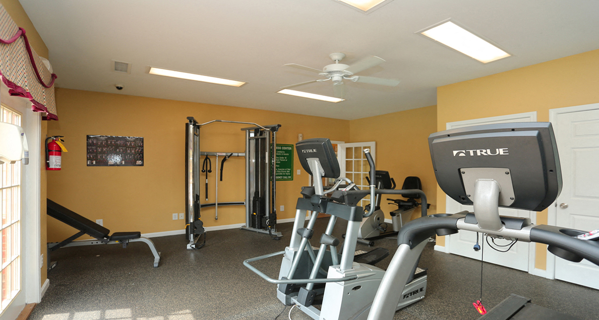 State-of-the-art fitness center with cardio and strengthening machines at The Columns at Paxton Lane, Lilburn, GA