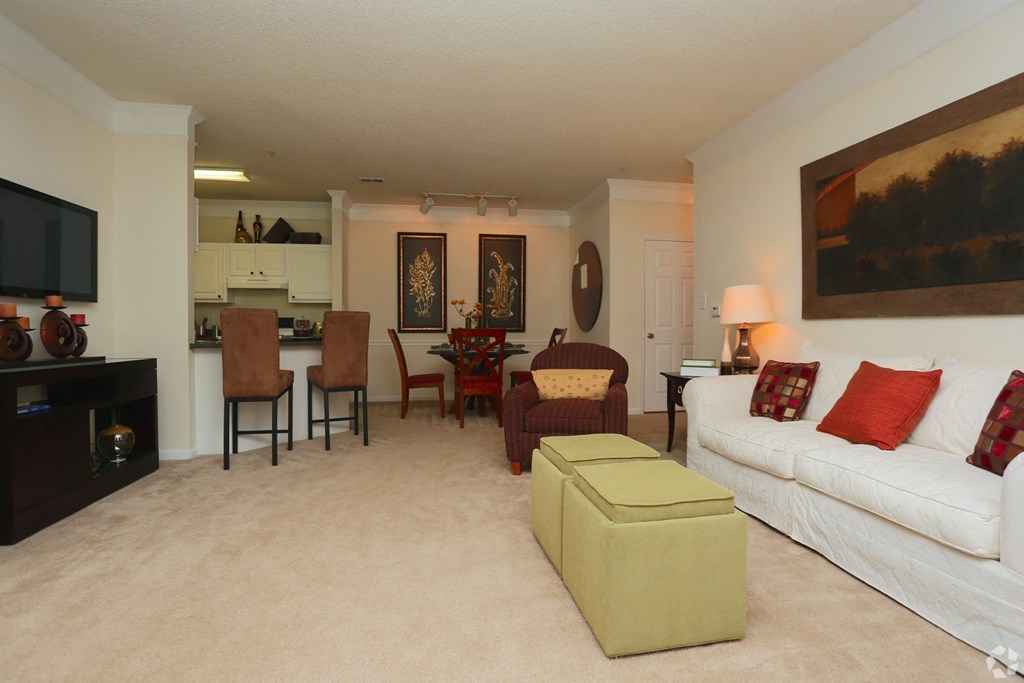 Semi-open concept floor plan with living room view into dining room and kitchen at The Columns at Paxton  Lane, 4305 Paxton Lane SW, Lilburn, Georgia 30047