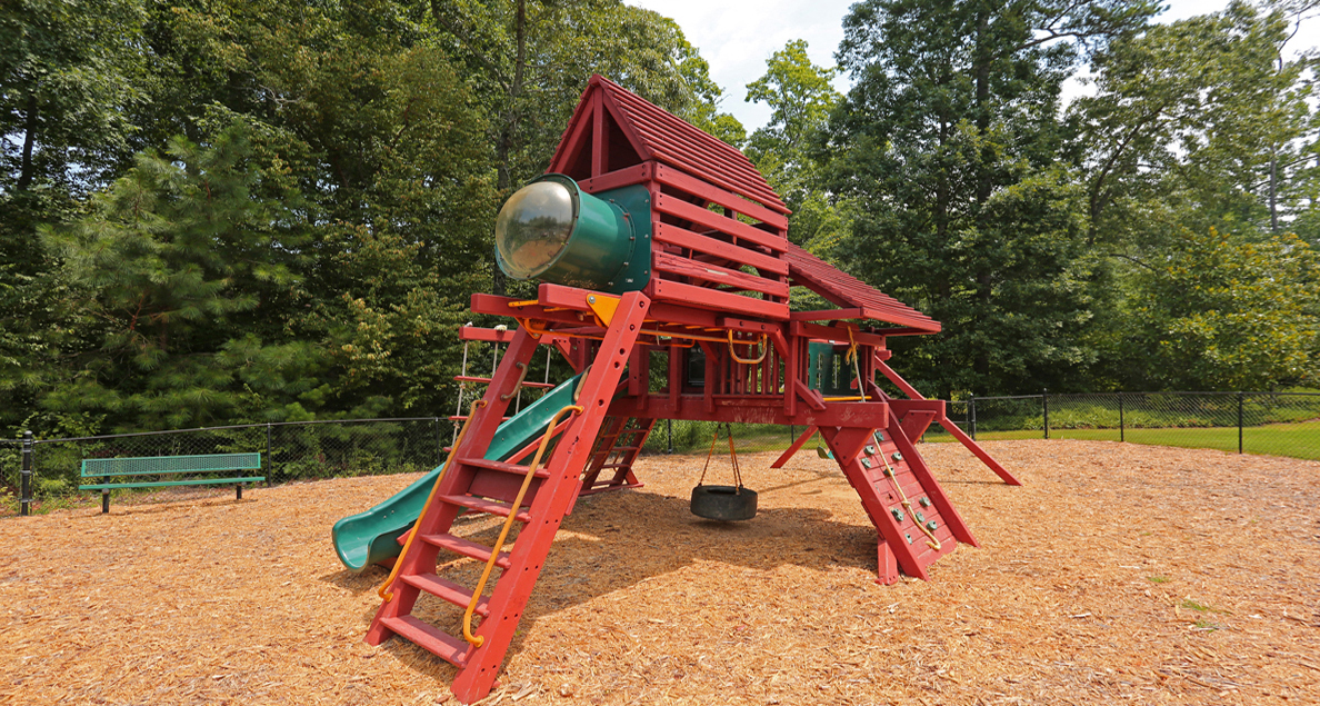 Community playground with slides and swings at The Columns at Paxton Lane, GA