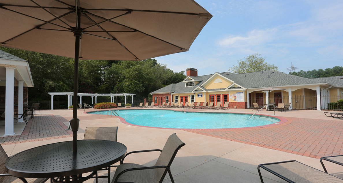 Pool deck with clubhouse view at The Columns at Paxton Lane, Lilburn, GA