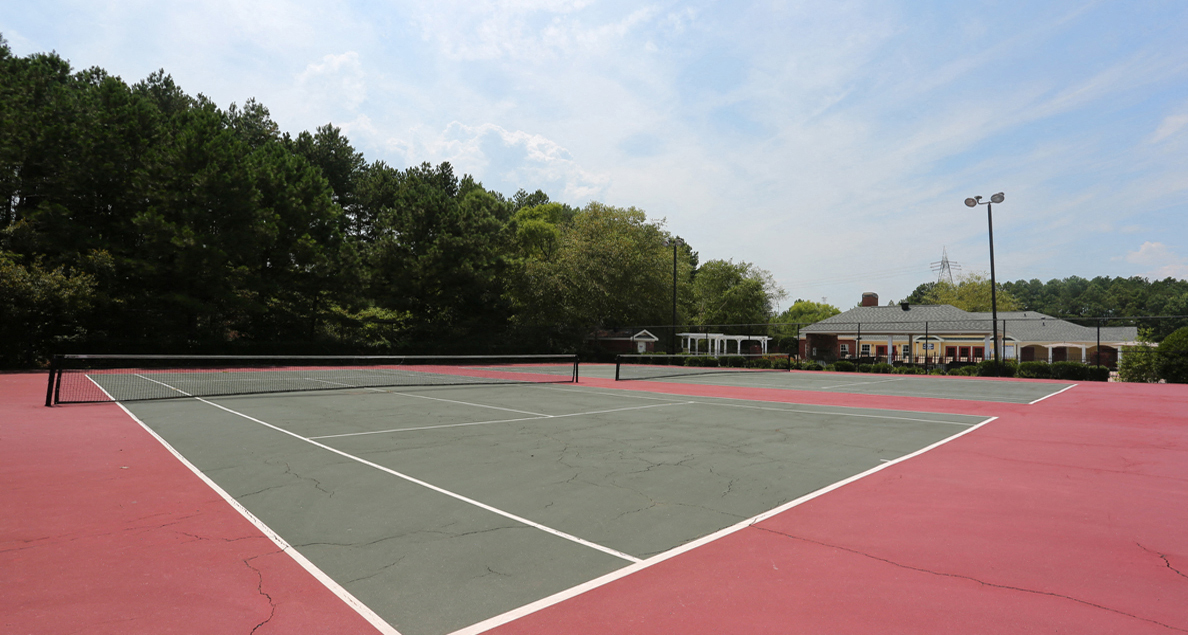 Well-lit tennis courts at The Columns at Paxton Lane, 4305 Paxton Lane SW, Lilburn, Georgia 30047