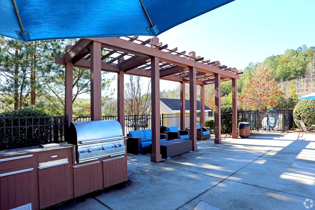 Outdoor entertainment area with grill and pergola at The Columns at Pilgrim Mill, Cumming, Georgia 30041