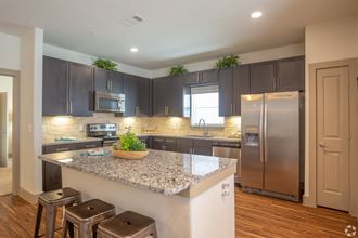 Luxury kitchen with granite countertops and stainless steel appliances, The Columns at Shadow Creek Ranch, Texas