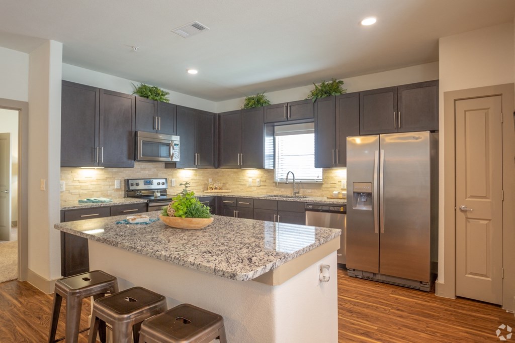 Luxury kitchen with granite countertops and stainless steel appliances, The Columns at Shadow Creek Ranch, Texas