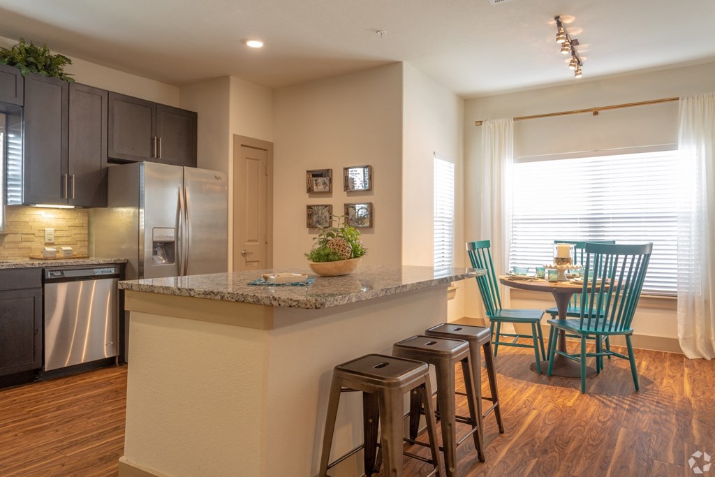 Large eat-in kitchen with island seating and dining area, The Columns at Shadow Creek Ranch, Pearland 77584