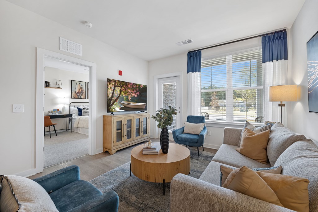 a living room with couches and chairs and a table