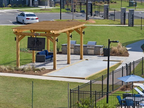 a large wooden pavilion with a tv in a park