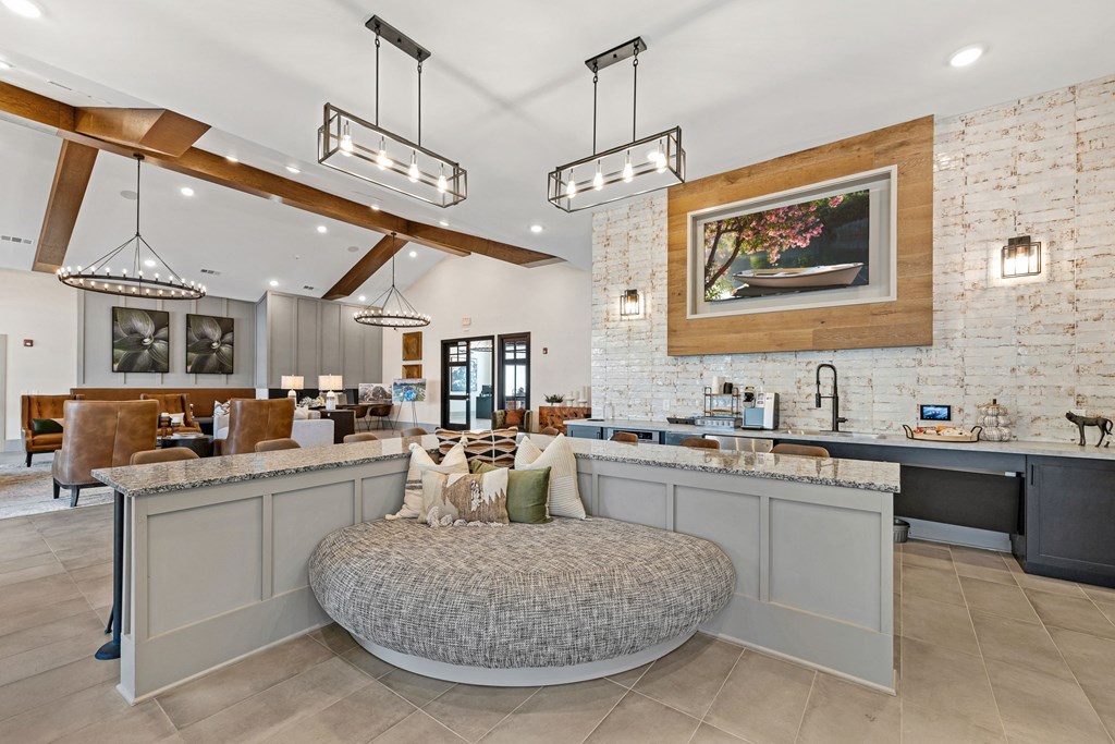 a large living room with a round couch in the middle