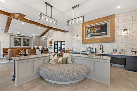 a large living room with a round couch in the middle