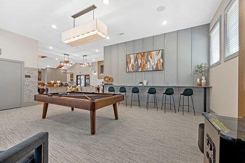 a game room with a pool table and a bar