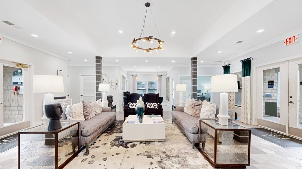 a living room filled with furniture and a large window