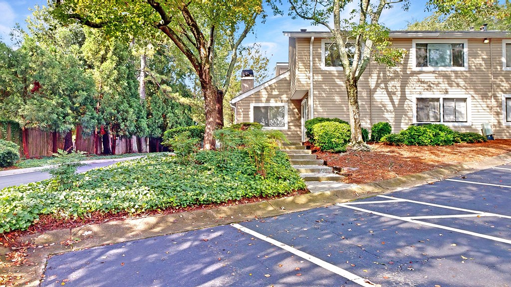 a home with a parking lot in front of it