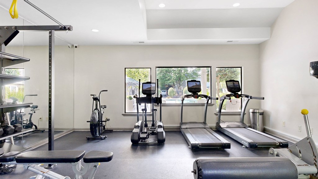 a gym with treadmills and other exercise equipment