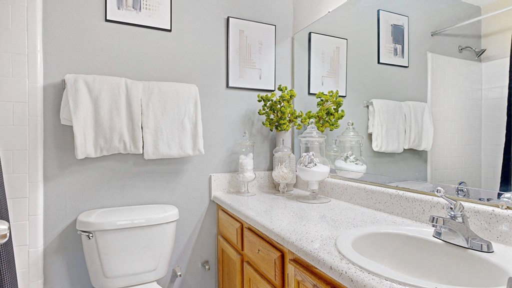 a small bathroom with a toilet sink and mirror