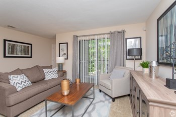 Spacious living room with sliding patio door and vertical blinds Spacious living room with sliding patio door and vertical blinds at The Columns at Vinings, GA - Photo Gallery 4