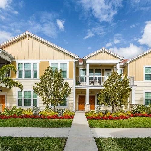 a large house with a sidewalk in front of it