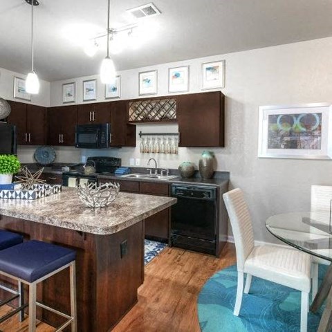 a kitchen with a bar and a table
