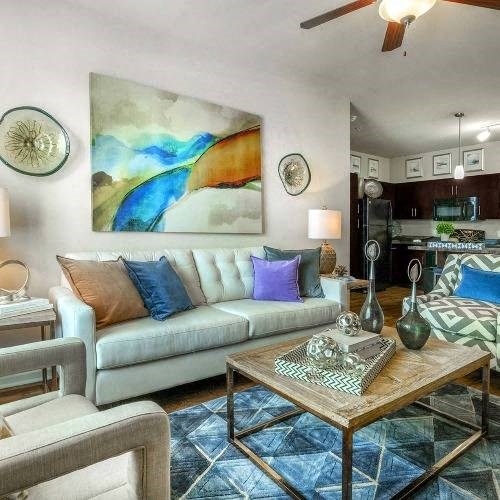 a living room filled with furniture and a painting