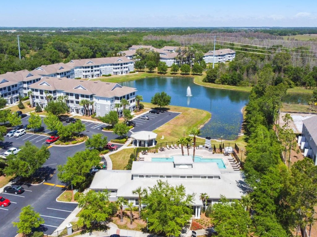 an aerial view of the resort with a sailboat in the lake