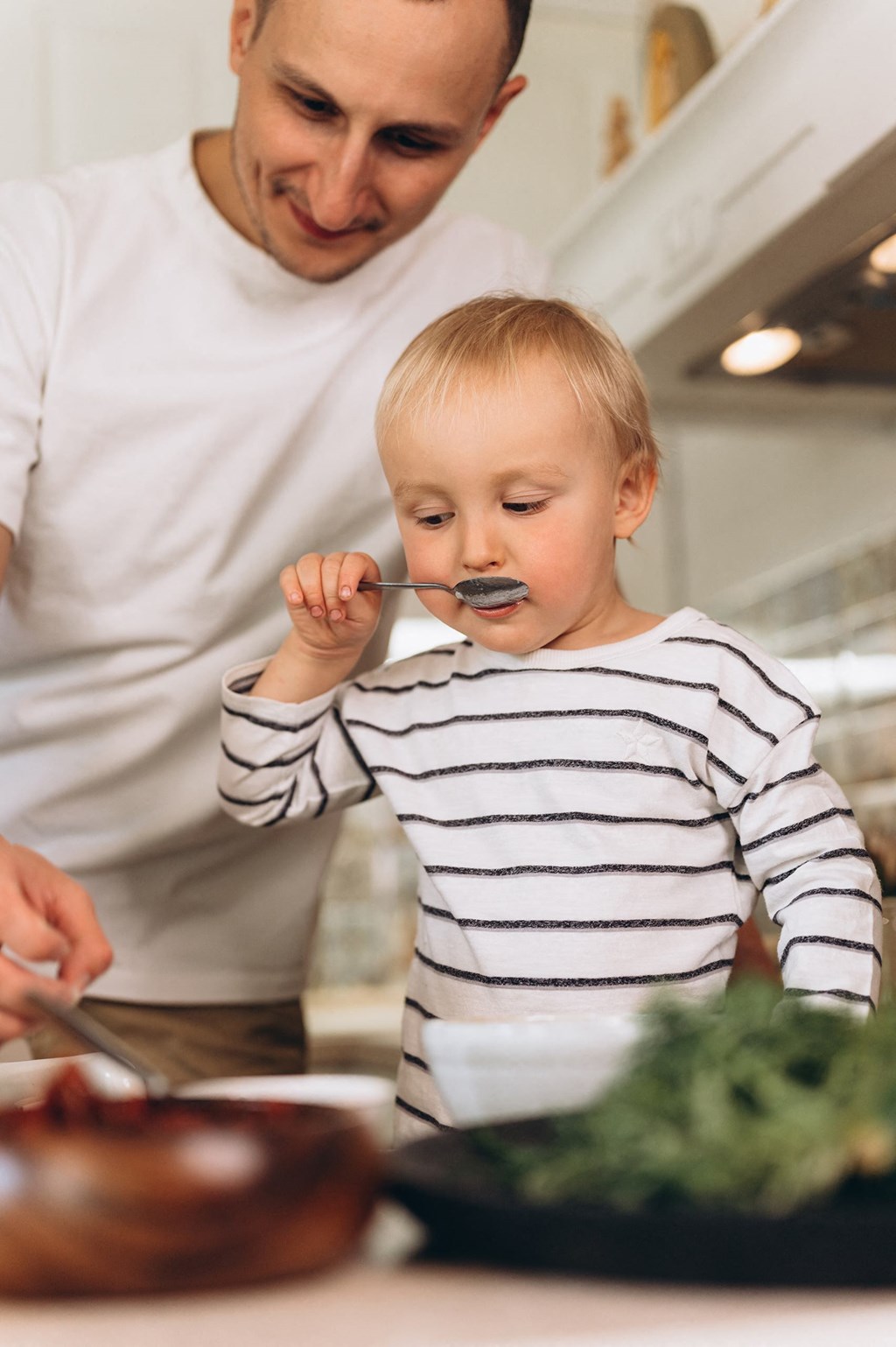 Father and son in the kitchen at The Corwyn South Point, McDonough, GA