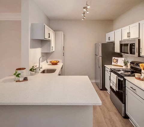 a kitchen with a white counter top and a refrigerator