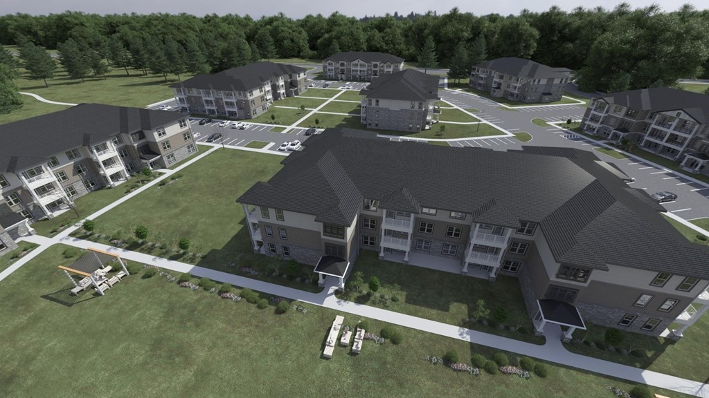 an aerial view of a large apartment complex with a helicopter parked in front of it