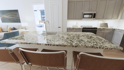 a kitchen with a large island and a living room in the background