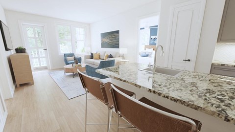 a kitchen with an island and a living room in the background