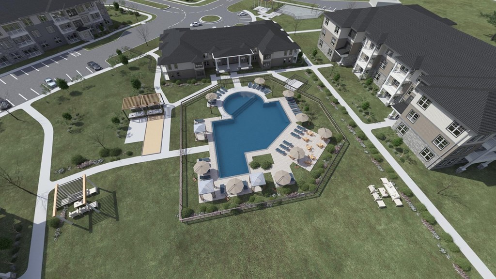 an aerial view of the resort style pool and hot tub at the abbey at dominion crossing