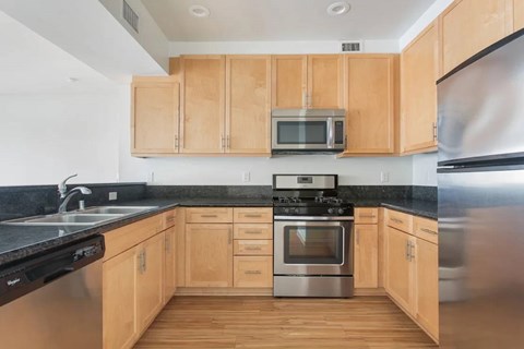 A kitchen with wooden cabinets and stainless steel appliances.