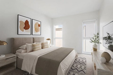 A bedroom with a large bed and two framed artworks on the wall.