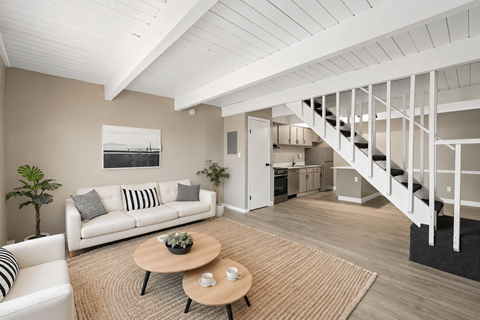 A living room with a white couch and a coffee table.