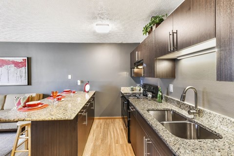 A kitchen with a counter and a sink.